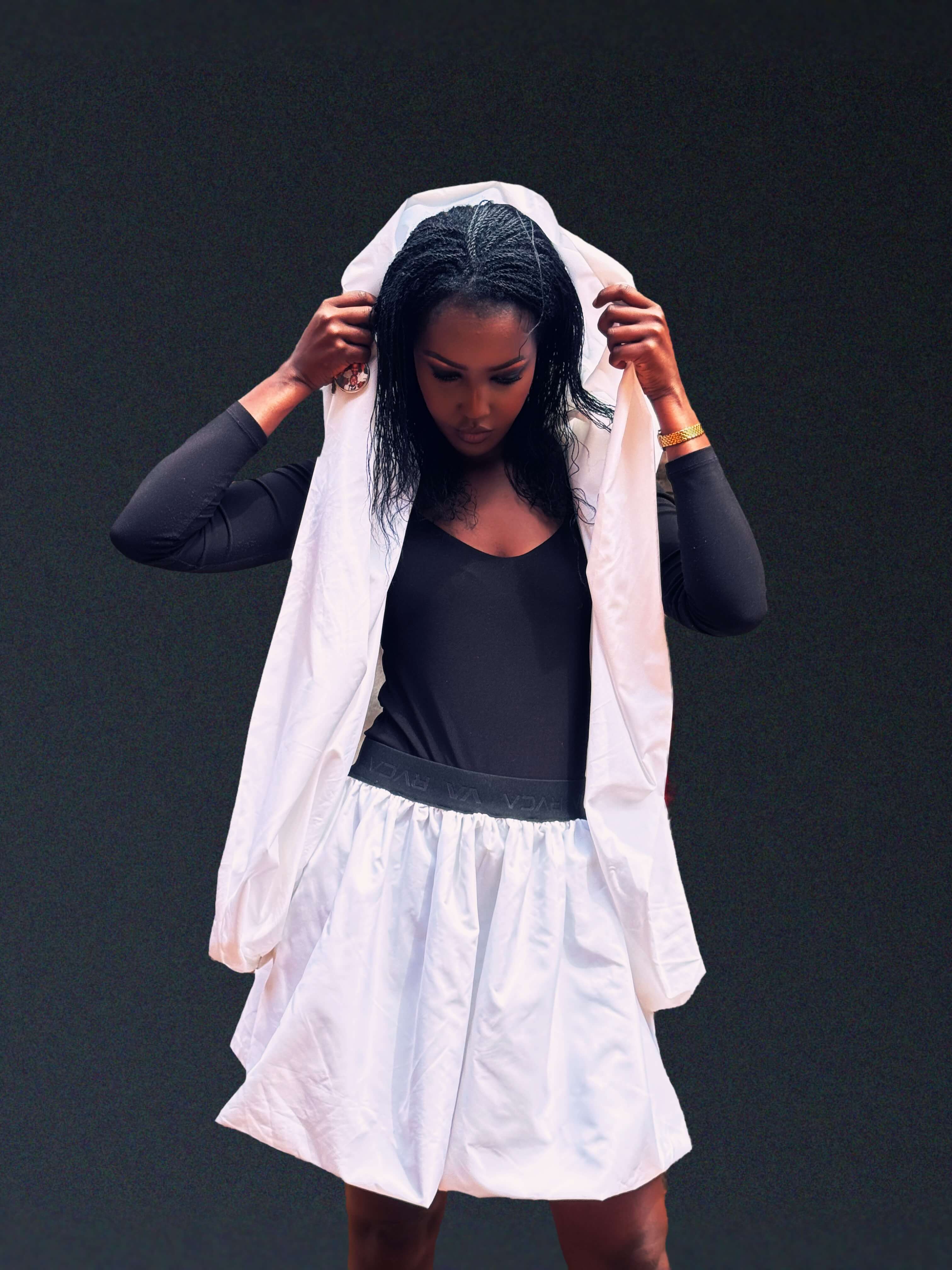 The Noor Convertible Coat, hood raised over the head