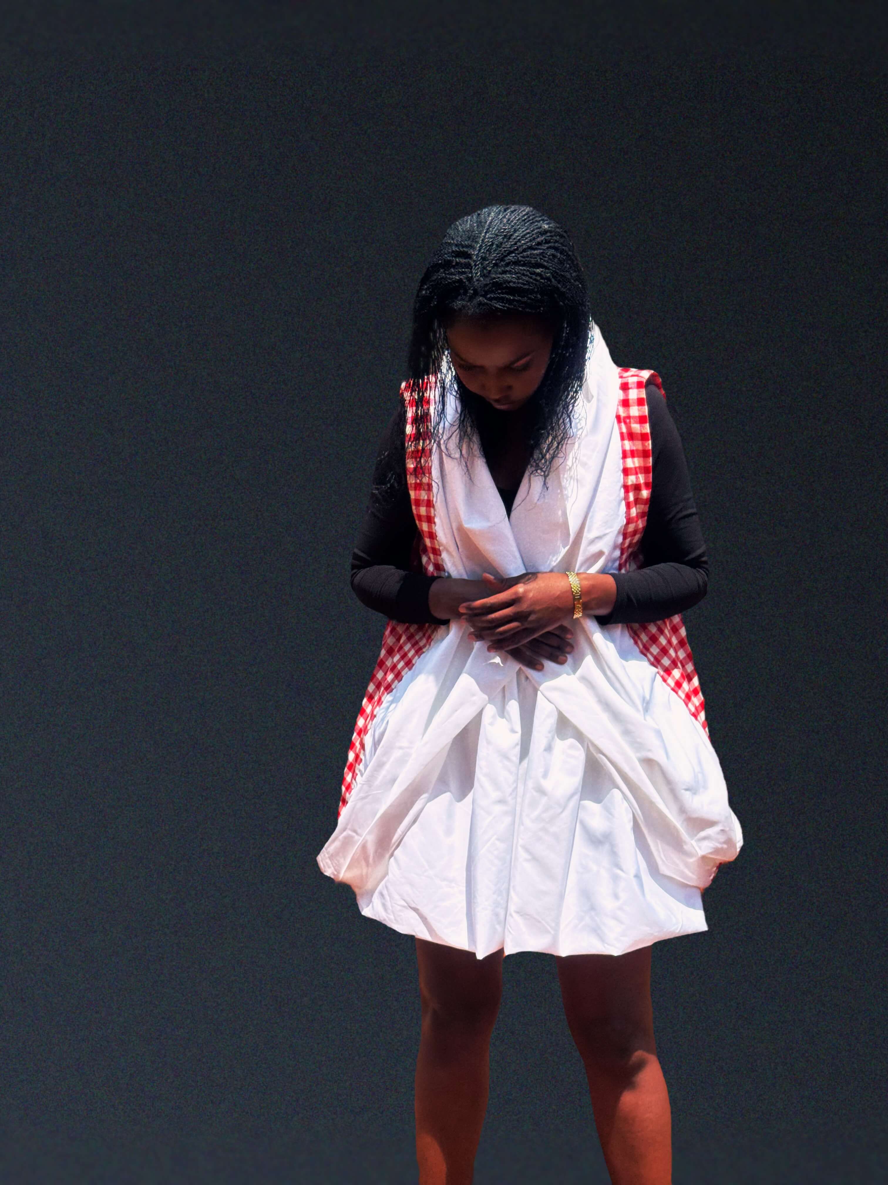 The Noor Convertible Coat, hood down, hands clasped